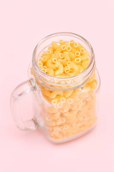 Uncooked Chifferi Rigati Pasta Glass Jar Pink Background Fat Unhealthy — Stock Photo, Image