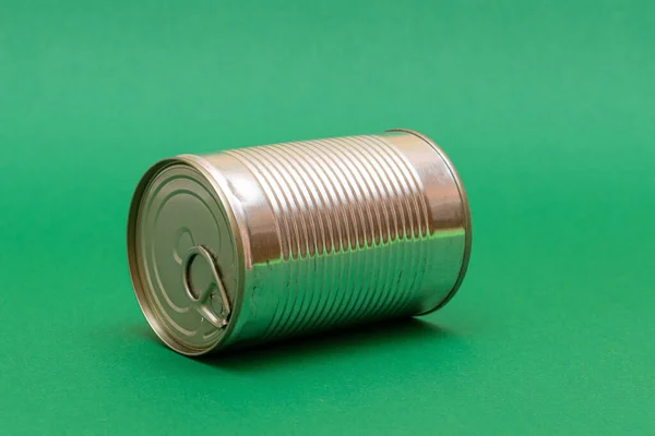 stock image Unopened Tin Can with Blank Edge on Green Background. Canned Food. Aluminum Can for Safe and Long Term Storage of Food. Steel Sealed Food Storage Container