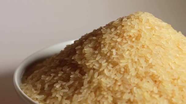Dry Uncooked Parboiled Rice Heap Rotating White Background Pile Raw — Stock Video
