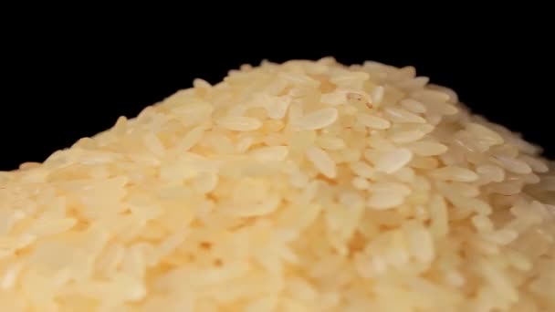 Dry Uncooked Parboiled Rice Heap Rotating Black Background Pile Raw — Stok video
