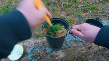 Camp Food. Cooking in a Hike Using a Small Cook Set - First Person View, Wide Angle. Food on the Trip. Traveler in a Spring Forest. Tourist in a Travel is Heating Food - POV Shot.