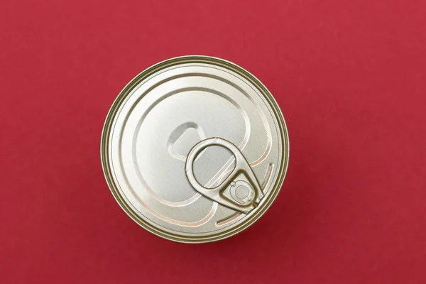 stock image Unopened Tin Can with Blank Edge on Red Background. Canned Food. Aluminum Can for Safe and Long Term Storage of Food. Steel Sealed Food Storage Container