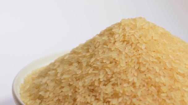Dry Uncooked Parboiled Rice Heap Rotating White Background Pile Raw — Stock Video