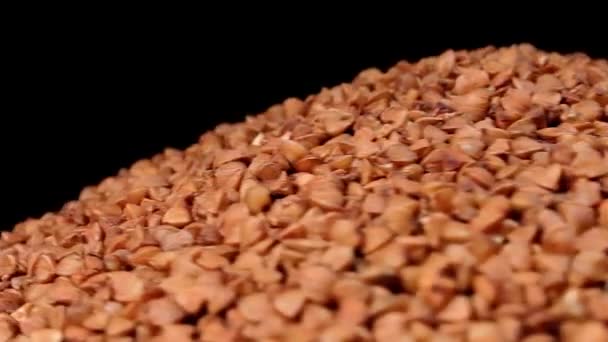 Сухий Розпечений Brown Buckwheat Groats Heap White Plate Rotating Black — стокове відео