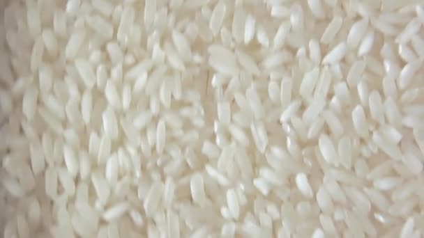 Dry Uncooked White Rice Background Slowly Moving Upward Top View — Stock Video