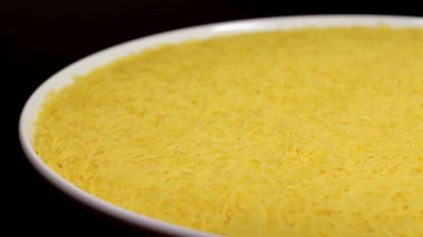 Raw Uncooked Noodles on White Plate Rotating against Black Background. Dry Vermicelli Turning Around. Raw Pasta