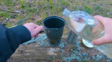 Camp Food. Cooking in a Hike Using a Small Cook Set - First Person View, Wide Angle. Food on the Trip. Traveler in a Spring Forest. Tourist in a Travel is Heating Food - POV Shot.