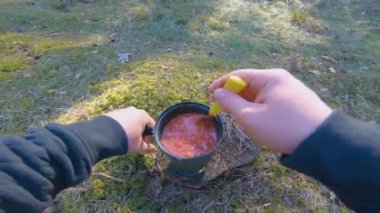 Camp Food. Cooking in a Hike Using a Small Cook Set - First Person View, Wide Angle. Food on the Trip. Traveler in a Spring Forest. Tourist in a Travel is Heating Food - POV Shot.