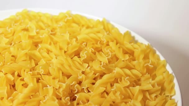 Uncooked Fusilli Pasta White Plate Rotating White Background Fat Unhealthy — Video Stock