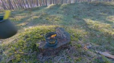 Camp Food. Cooking in a Hike Using a Small Cook Set - First Person View, Wide Angle. Food on the Trip. Traveler in a Spring Forest. Tourist in a Travel is Heating Food - POV Shot.