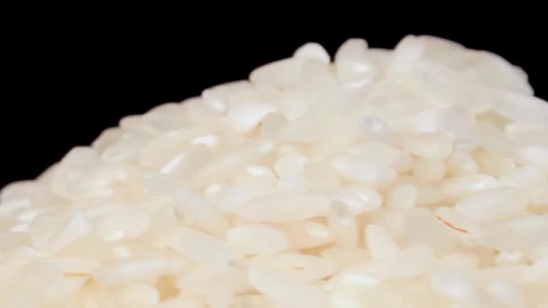 Dry Uncooked White Rice Heap White Plate Rotating Black Background – stockvideo