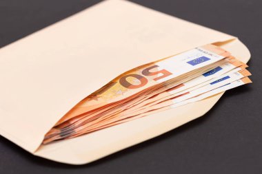 An Orange Paper Envelope with Stack of 50-Euro Banknotes Inside. Salary in Cash. Tax-Free System. Euro Currency. Payments with No Taxes. Orange Paper Money. A Lot of Fifty-Euro Bills clipart