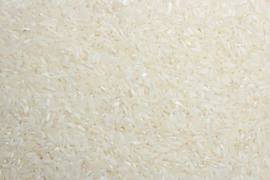 Kuru Pişmemiş Beyaz Pirinç Arkaplanı - Üst Manzara, Düz Yat. Çiğ Uzun Taneli Pirinç. Asya mutfağı ve kültürü. Sağlıklı beslenme malzemeleri. Diyet Yemekler