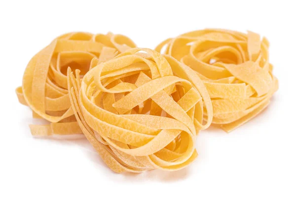 stock image Three Classic Italian Raw Egg Fettuccine - Isolated on White Background. Dry Twisted Uncooked Pasta. Italian Culture and Cuisine. Raw Golden Macaroni Pattern - Isolation
