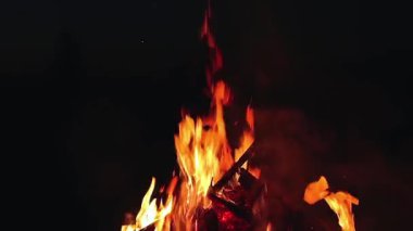 Büyük Kamp Ateşi, Sabah Erkenden veya Akşam Mavi Gök 'e Karşı Yanıyor. Ateşe odun. Uçan Kıvılcım. Seyahat ve Turizm Konsepti. Yazın Devasa Şenlik Ateşi 'nden Kalanlar - Sabit Çekim, Yavaş Hareket