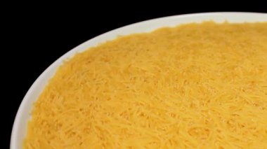 Raw Uncooked Noodles on White Plate Rotating against Black Background. Dry Vermicelli Turning Around. Raw Pasta