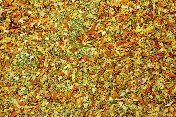 Vibrant and Colored Vegetable Seasoning Mix: A Culinary Canvas of Aromatic Seasoning - Textured Background for Gourmet Cooking. The Harmonious Combination of Fresh Herbs and Spices - Top View