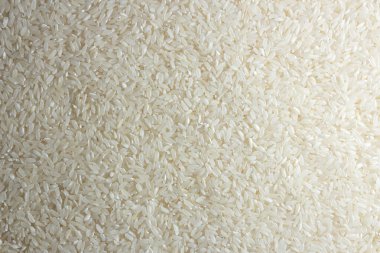 Kuru Pişmemiş Beyaz Pirinç Arkaplanı - Üst Manzara, Düz Yat. Çiğ Uzun Taneli Pirinç. Asya mutfağı ve kültürü. Sağlıklı beslenme malzemeleri. Diyet Yemekler