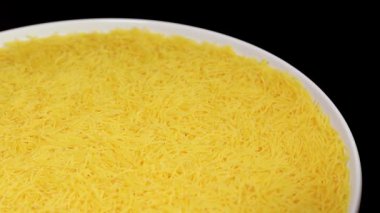 Raw Uncooked Noodles on White Plate Rotating against Black Background. Dry Vermicelli Turning Around. Raw Pasta