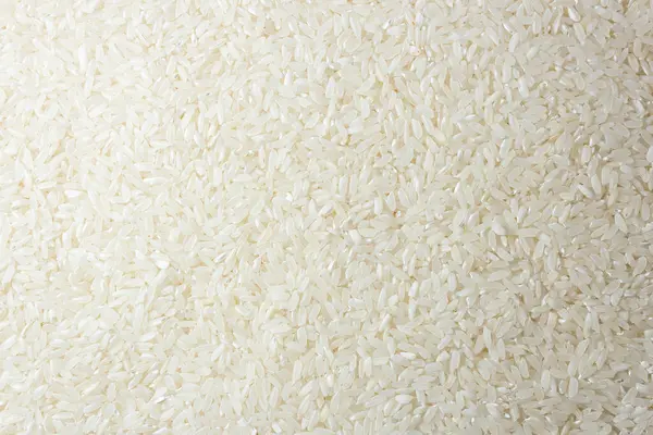 Kuru Pişmemiş Beyaz Pirinç Arkaplanı - Üst Manzara, Düz Yat. Çiğ Uzun Taneli Pirinç. Asya mutfağı ve kültürü. Sağlıklı beslenme malzemeleri. Diyet Yemekler