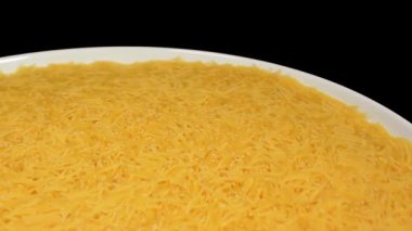 Raw Uncooked Noodles on White Plate Rotating against Black Background. Dry Vermicelli Turning Around. Raw Pasta