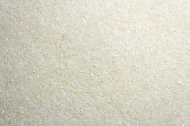 Kuru Pişmemiş Beyaz Pirinç Arkaplanı - Üst Manzara, Düz Yat. Çiğ Uzun Taneli Pirinç. Asya mutfağı ve kültürü. Sağlıklı beslenme malzemeleri. Diyet Yemekler