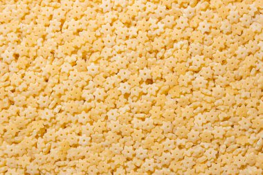 Pişmemiş Stelline Makarna: Gurme Aşçılığı İçin Canlı ve Dokulu Bir Arkaplan Oluşturan Stelline Makarna Mutfağı. Kuru makarna. Raw Macaroni - Top View, Düz Yat