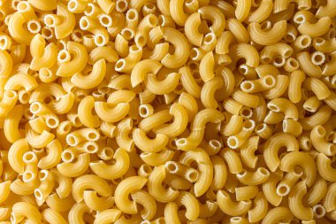 Pişmemiş Chifferi Rigati Pasta: Bir Chifferi Rigati Mutfak Tuvali, Gurme Aşçılık İçin Canlı ve Dokulu Bir Arkaplan Oluşturuyor. Kuru makarna. Raw Macaroni - Top View, Düz Yat