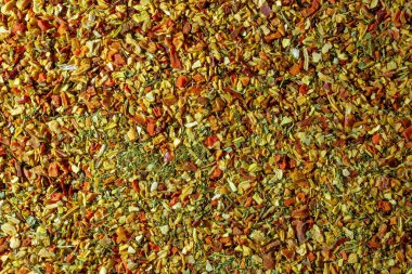 Vibrant and Colored Vegetable Seasoning Mix: A Culinary Canvas of Aromatic Seasoning - Textured Background for Gourmet Cooking. The Harmonious Combination of Fresh Herbs and Spices - Top View clipart