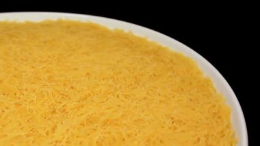 Raw Uncooked Noodles on White Plate Rotating against Black Background. Dry Vermicelli Turning Around. Raw Pasta