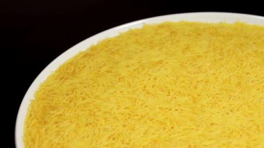 Raw Uncooked Noodles on White Plate Rotating against Black Background. Dry Vermicelli Turning Around. Raw Pasta