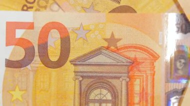 50 Euro 'luk banknotlar, döner para arkaplanı - Top View, Macro. Euro Para Birimi. Turuncu Kağıt Para. Bir sürü 50 Euro 'luk banknot. Ekonomi, Nakit ve Para Tasarruf Konsepti - Yavaş Dönüşüm Sağı