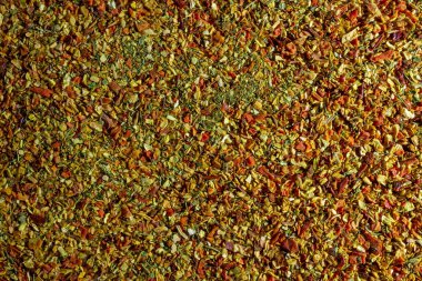 Vibrant and Colored Vegetable Seasoning Mix: A Culinary Canvas of Aromatic Seasoning - Textured Background for Gourmet Cooking. The Harmonious Combination of Fresh Herbs and Spices - Top View clipart