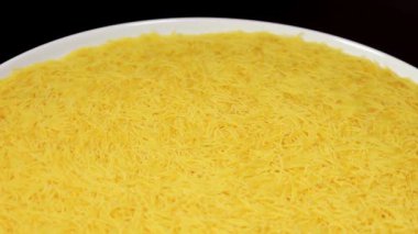 Raw Uncooked Noodles on White Plate Rotating against Black Background. Dry Vermicelli Turning Around. Raw Pasta