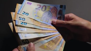 Elde Para Saymak. Avrupa Birliği Parası. Siyah Masa 'da Beyaz Kadın Farklı Euro Banknotları Sayıyor - Yakın plan. Renkli Kağıt Para. Avro Elde. Gelir, Tasarruf ve Harcama Konsepti