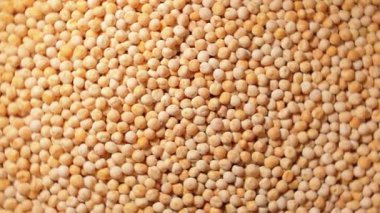 Pişmemiş Sarı Bezelyeler: Kuru Bezelye Mutfak Tablosu, Dokulu Arkaplan - Üst Görünüm, Döndürme. Dağıtılmış Çiğ Bezelyeleri Dönüştürmek. Sağlıklı Yeme İçindekiler - Döndürme