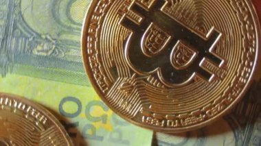 100 Euro 'luk banknotlarda Bitcoin Sikkeleri - Top View, Macro. Euro Para Nakiti ve Kripto Para Birimi. Yüz Euro 'luk banknot. Finans, Borsa, Engelleme Zinciri ve Elektronik Para Konsepti - Çevirme Sağı