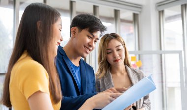 Successful team of new business startup people working together in creative office, happy euphoric proud Asian male and female professional winner feel overjoyed