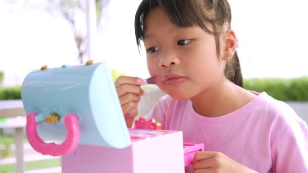 Adorable Little Child Asian Girl Paints Her Mouth Pink Children — 비디오