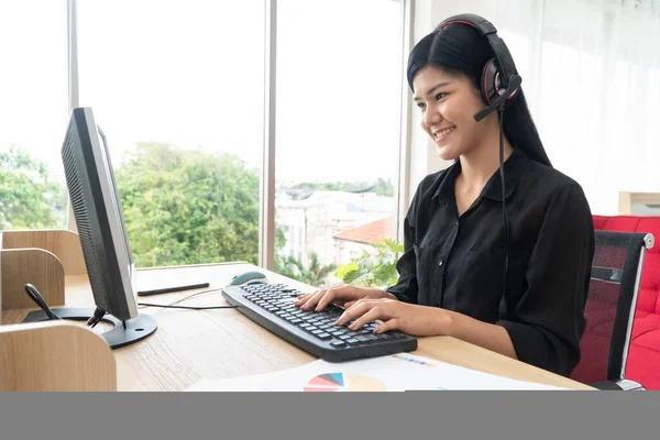 Asian business woman Video Conference for talk to colleagues work from home office wear headphones,  girl student talking by video conference call, female teacher trainer from home at living room