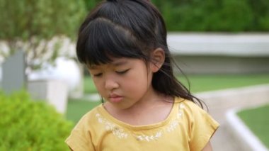 Portrait of Asian angry and sad little girl on white isolated background, The emotion of a child when tantrum and mad, expression of grumpy emotion. Kid emotional control concept