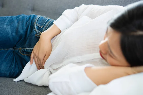 Unhappy Asian Woman Sitting Sofa Holding Stomach Suffering Abdominal Pain — Stock Photo, Image