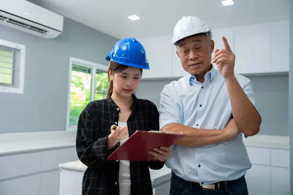 Senior home inspector checking home defects and teaching young engineers, before handing it over to client. Young engineers learn home inspection with Senior, Real estate, and renovation concepts.
