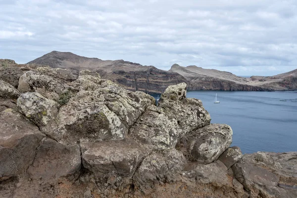 stock image landscape with igneous rocks on barren slopes of cove on Atlantic ocean, shot in bright fall light at Baia d Abra, Madeira, Portugal