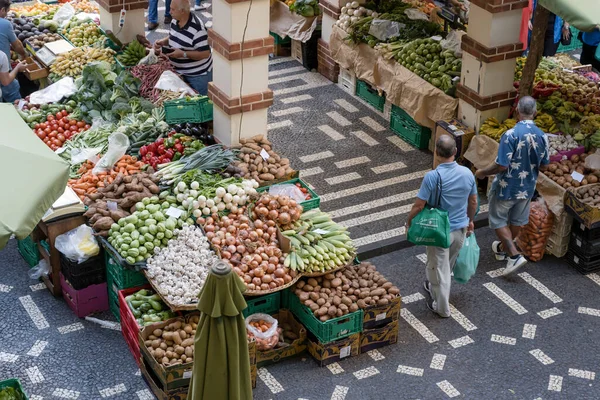 stock image FUNCHAL, 2022 october 14, cityscape with sale at vegetable stall around pillar in coverd market courtyard, shot in bright fall light on 14 october 2022 at Funchal, Madeira, Portugal