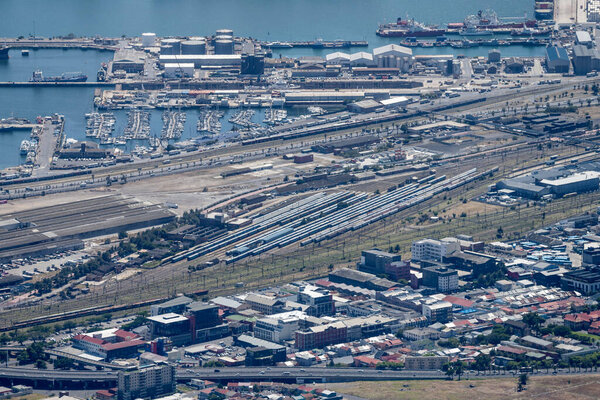CAPE TOWN, 2023 january 10, aerial cityscape with harbor quays and large rail yard, shot in bright summer light on january 10, 2023 at Cape Town, Western Cape, South Africa