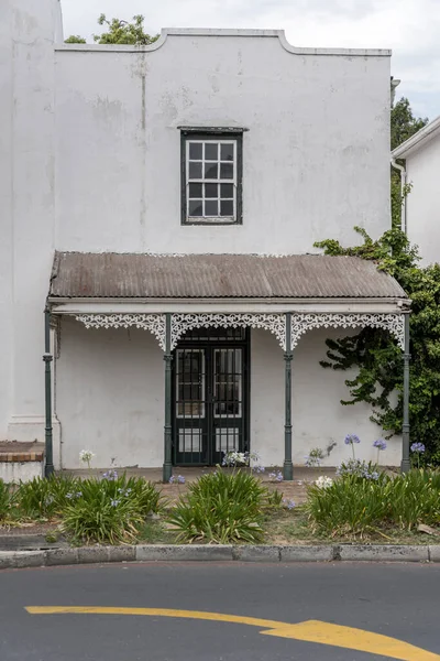 stock image cityscape with small porch with iron cast decoration, shot in bright cloudy summer light, Stellenbosch, Western Cape, South Africa