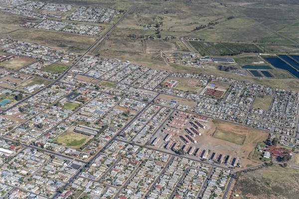 stock image aerial landscape, from a glider,  with houses and roads of residential neighborhood, shot from west in bright summer light, Worcester, Western Cape, South Africa