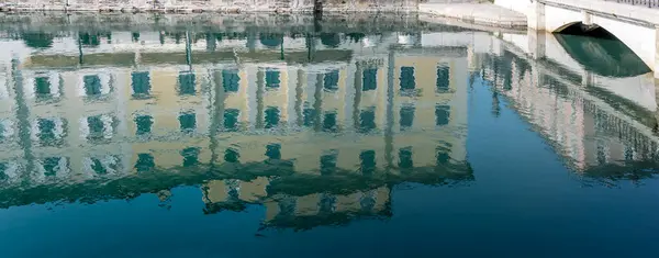 stock image cityscape with monumental facades reflecting in Canal Grande waters, shot in bright light at Trieste, Friuli, Italy