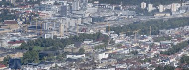 Almanya 'nın Stuttgart kentindeki televizyon kulesinden çekilen, tren istasyonu binaları ve raylarıyla dolu bir şehir.